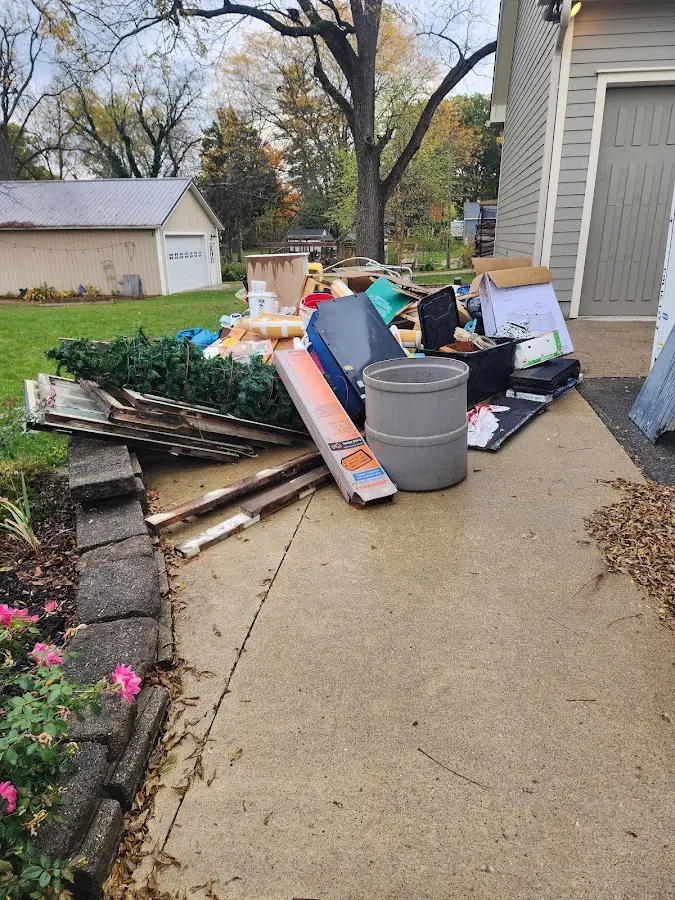 Dumpster being loaded with debris for 3 Yard Dumpster Rental in Hopedale